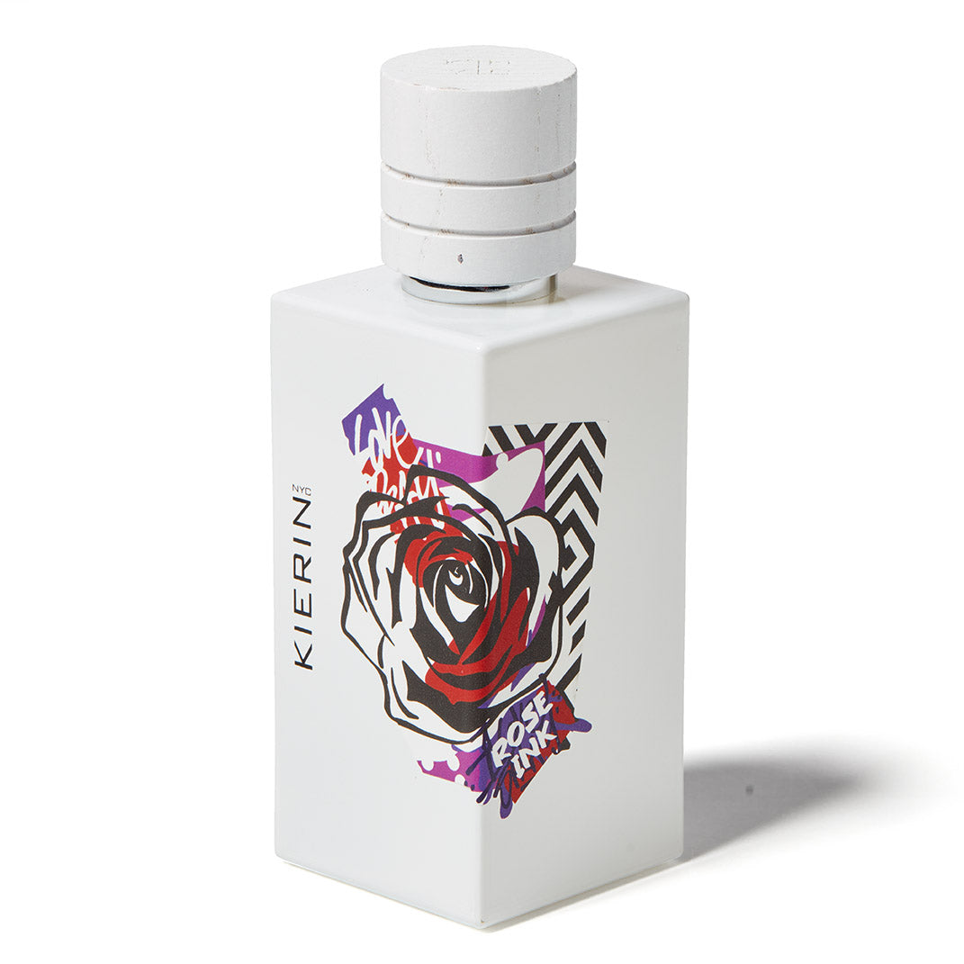 KIERIN Rose Ink perfume bottle with rose tattoo artwork, accompanying an article about tattoo culture and fragrance.