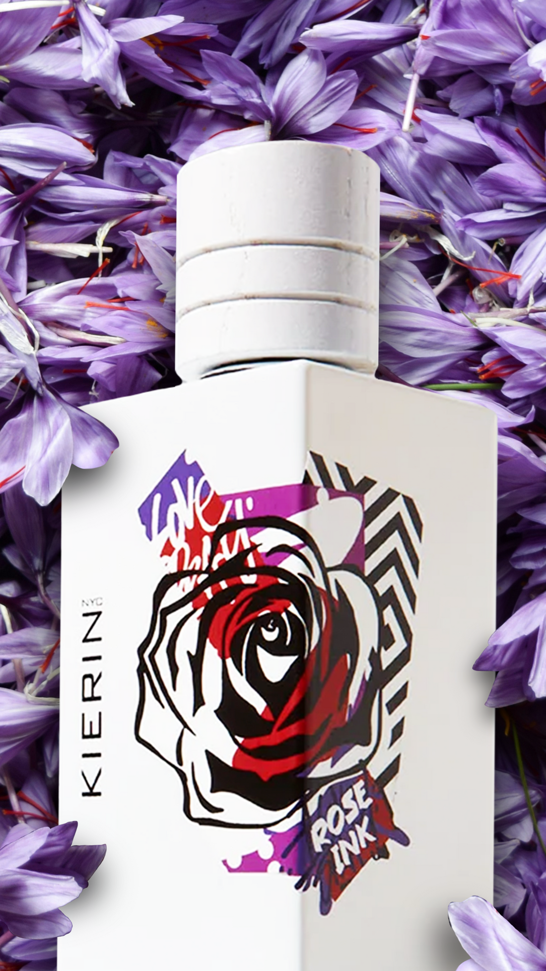 Perfume bottle with a bold geometric rose design labeled "Rose Ink" by KIERIN NYC, set against a backdrop of vibrant purple petals.