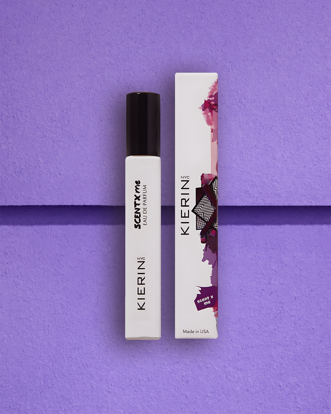 KIERIN NYC "SCENT*ME" perfume bottle and box on a textured purple surface. The design is sleek, with abstract art on the box, evoking elegance.