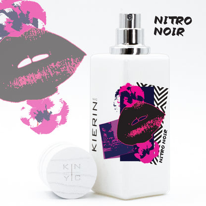 KIERIN Nitro Noir perfume with pink Pop Art label, exposed atomizer and cap alongside.
