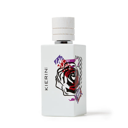 KIERIN Rose Ink perfume bottle with rose tattoo artwork, photographed from a low angle.