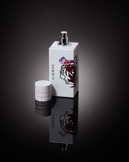 KIERIN Rose Ink perfume bottle and removed cap reflected on a dark surface.