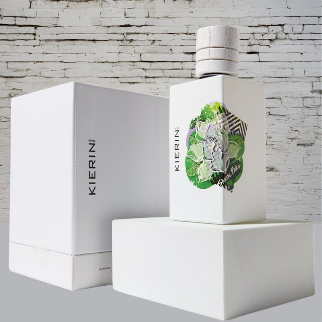 KIERIN Santal Park 100 ml perfume and white box against a white brick wall.