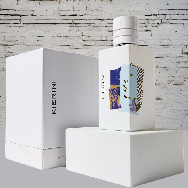 KIERIN Santal Sky 100 ml perfume and white box against a white brick wall.