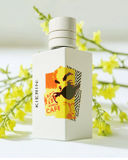 KIERIN Sunday Brunch perfume bottle beside yellow flowering branches.
