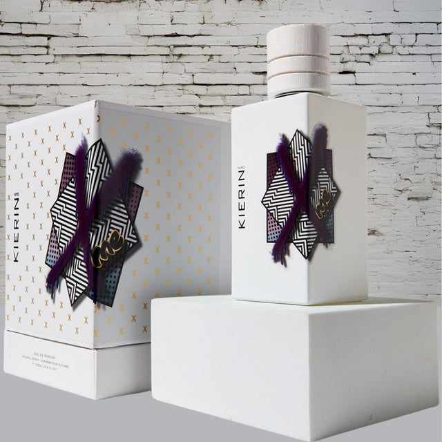 KIERIN ScentXme perfume and box against a white brick wall.